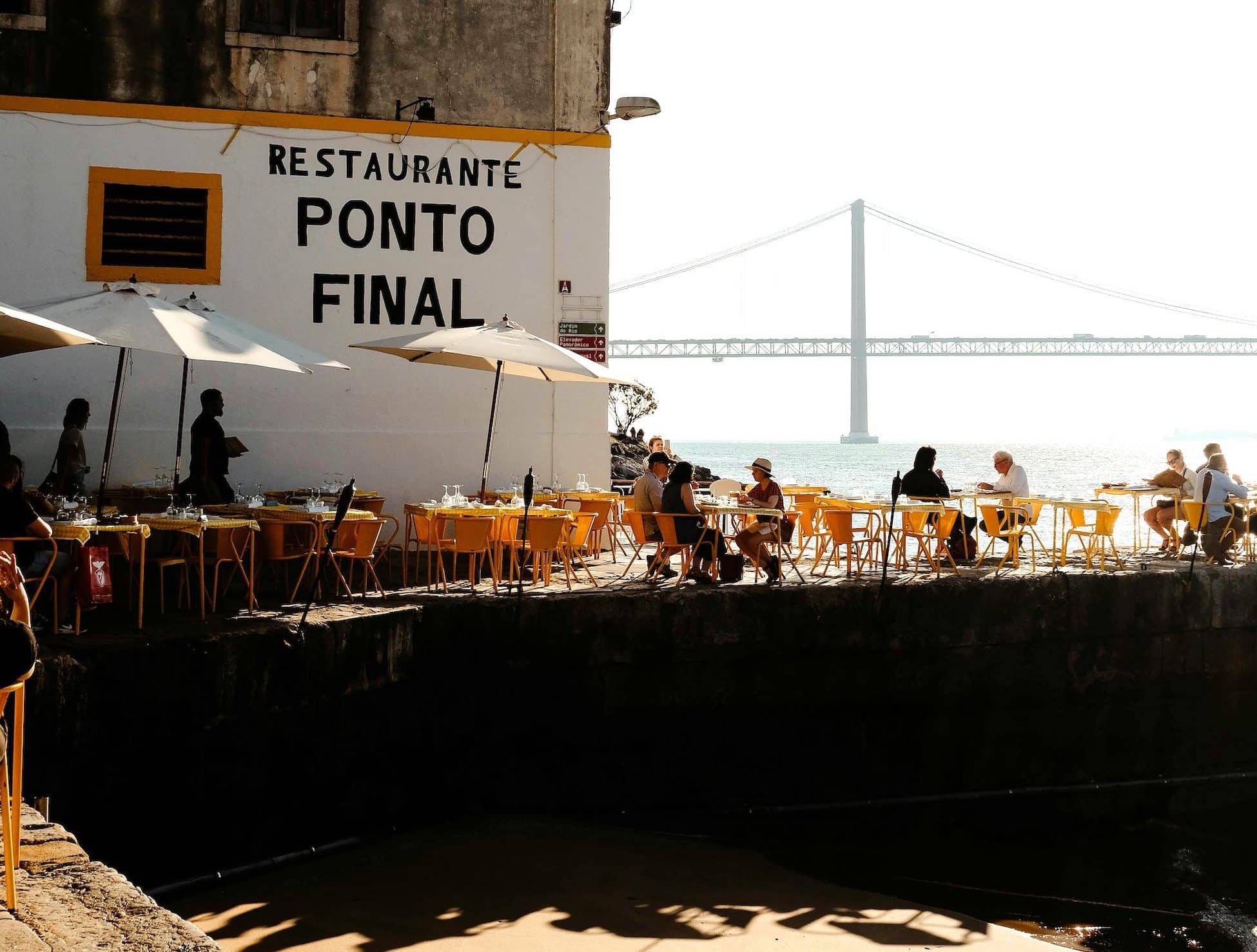 Locals enjoying a meal at a traditional Portuguese tasca, surrounded by classic dishes and a warm atmosphere.