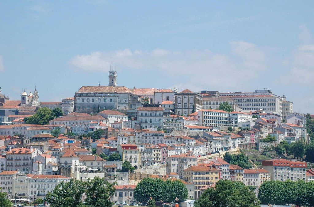 Scenic view of Coimbra’s old city walls and historic buildings, emphasizing the Almedina district’s historical significance.