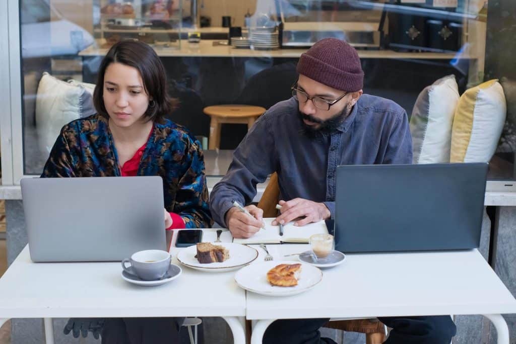 Remote worker using a laptop at a Lisbon café, highlighting Portugal’s digital nomad-friendly environment.