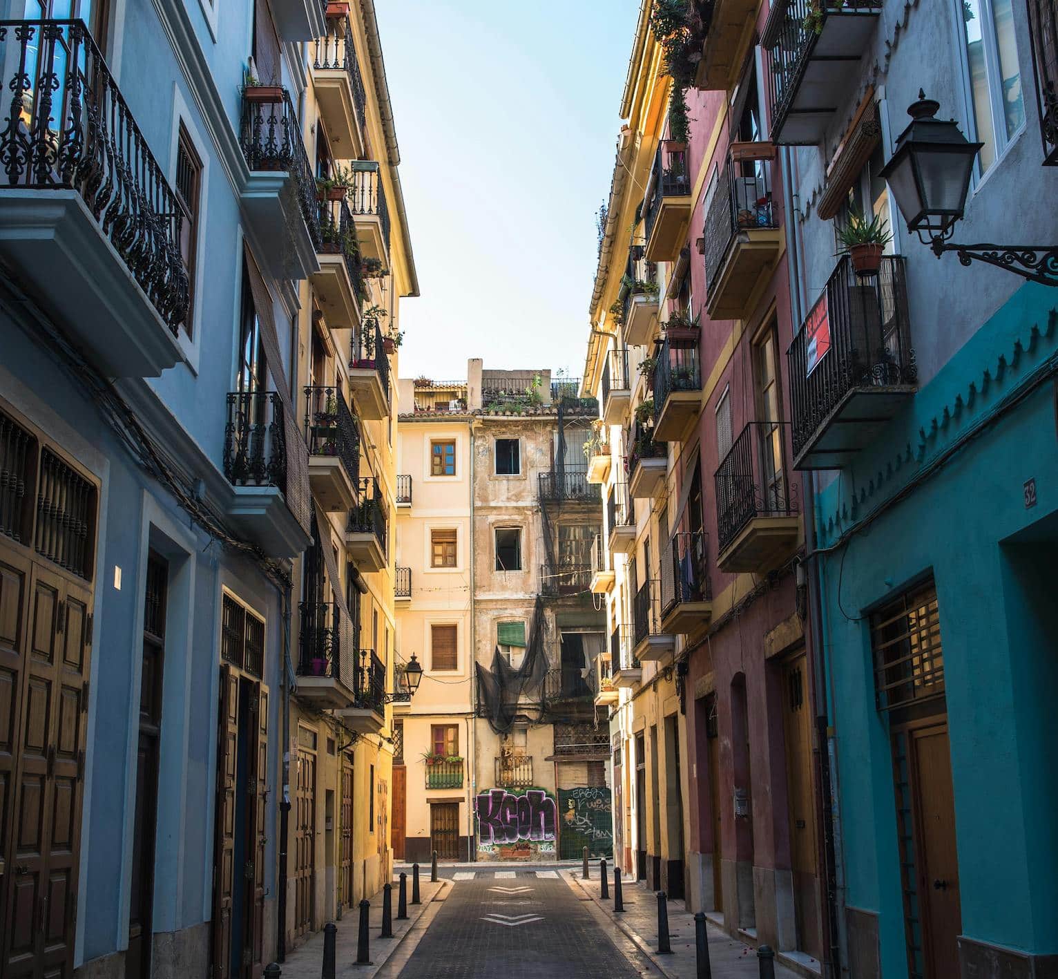 A vibrant street scene in Cabanyal, Valencia, showcasing the neighborhood’s colorful architecture and local life.
