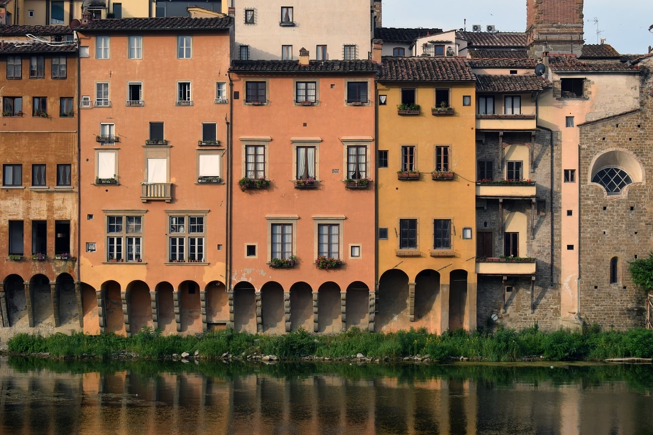 Traditional Saragozza apartments in Bologna, Italy, surrounded by tree-lined streets and local trattorias, reflecting the district's outdoor lifestyle.