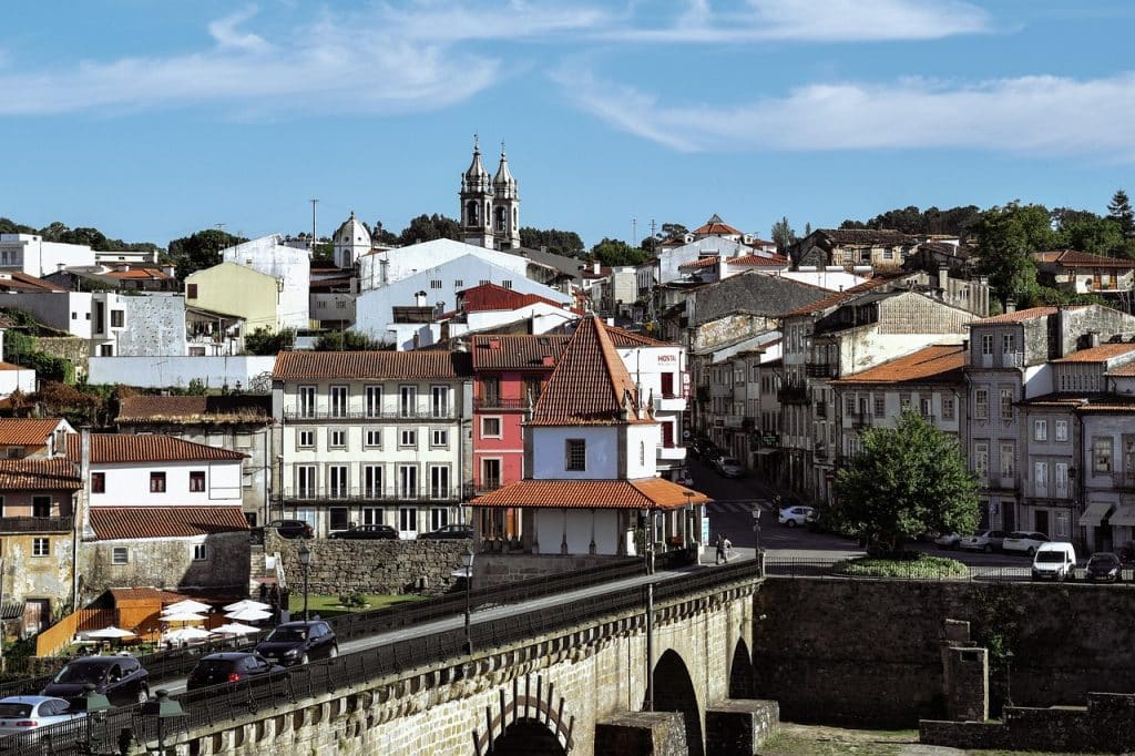 Colorful residential street in Maximinos, Braga, showcasing local shops and vibrant neighborhood life.