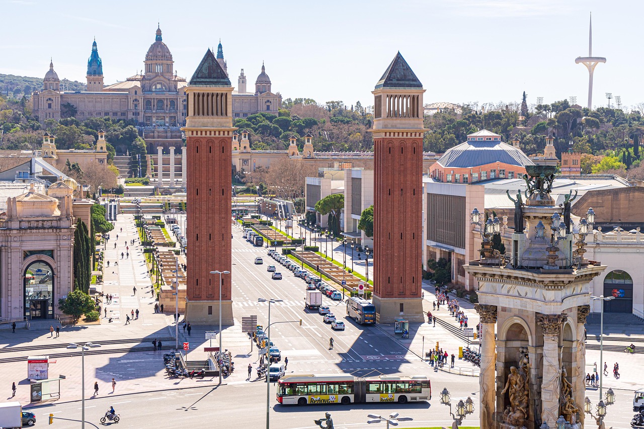 A top view of Barcelona showcasing its architecture, traffic, people shopping, and vibrant city life.