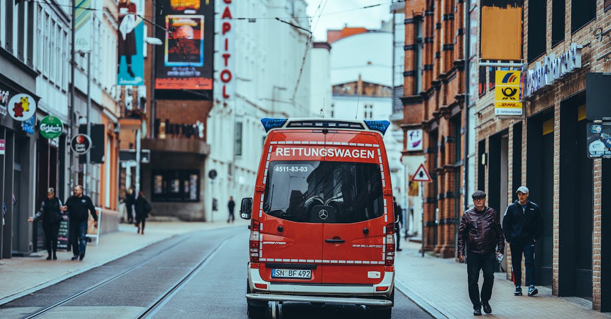A German ambulance parked in an urban setting, symbolizing the importance of public and private health insurance for emergency medical care.