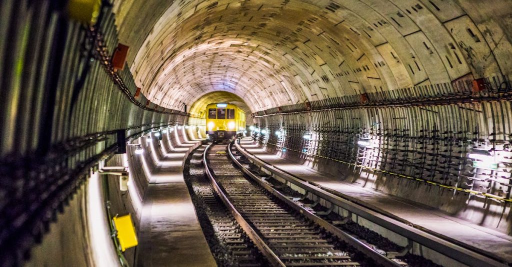 Dramatic view of a Berlin subway tunnel with a train approaching, showcasing Germany’s modern public transport infrastructure and safety measures.