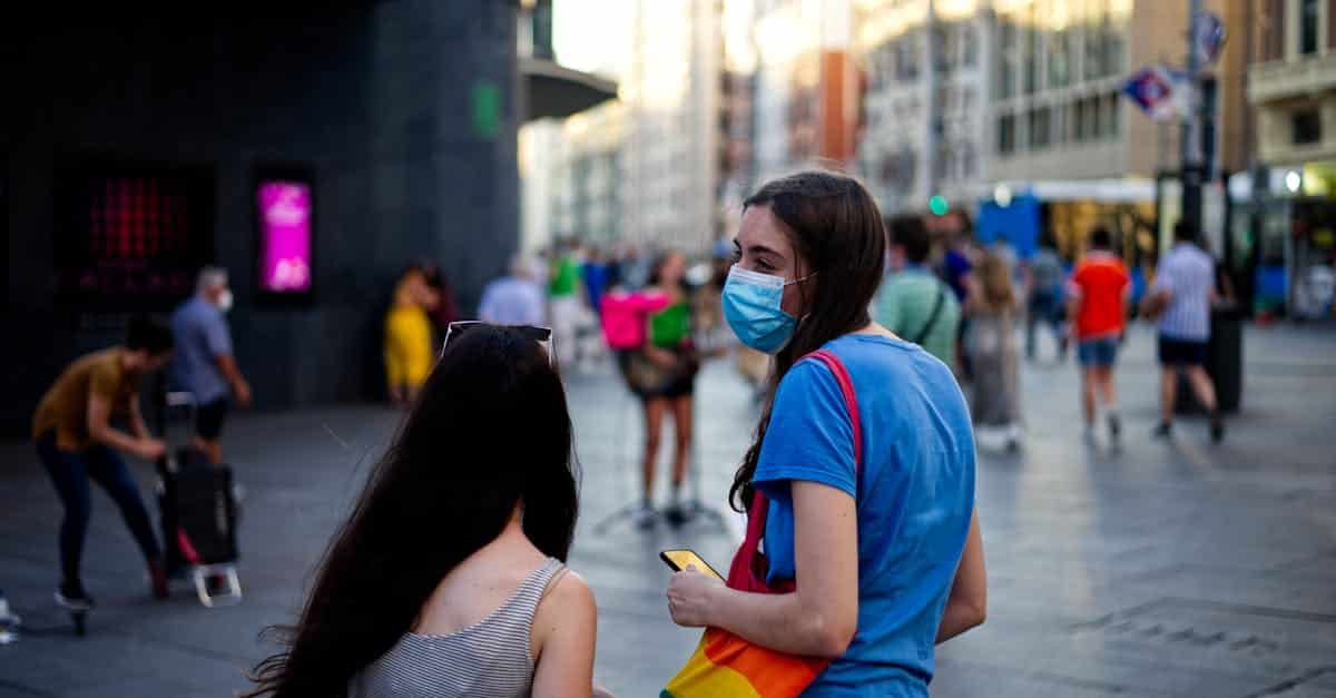 A vibrant street scene in Chueca, Madrid, showcasing the LGBTQ+ oasis with rainbow flags and inclusive spaces.