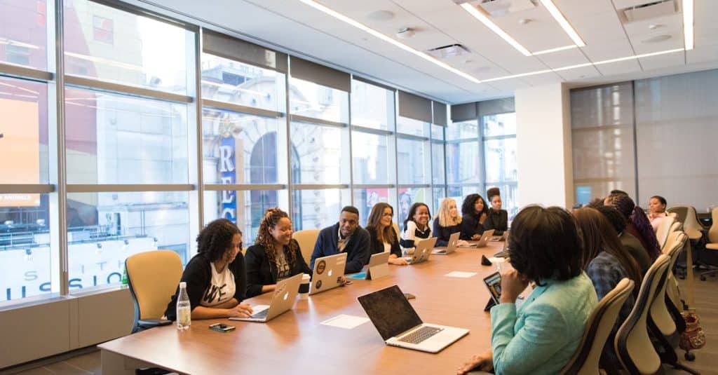 A diverse team of business professionals collaborating in a modern meeting room, representing Berlin’s international work culture for expats.