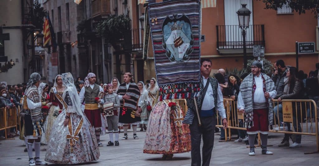 Traditional clothing parade in Valencia, Spain, featuring vibrant fallera dresses, historic costumes, and cultural heritage celebrations.