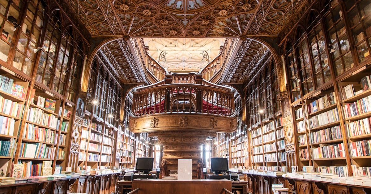 Visitors exploring the ornate staircase inside Livraria Lello in Porto, known for its exquisite architectural details.