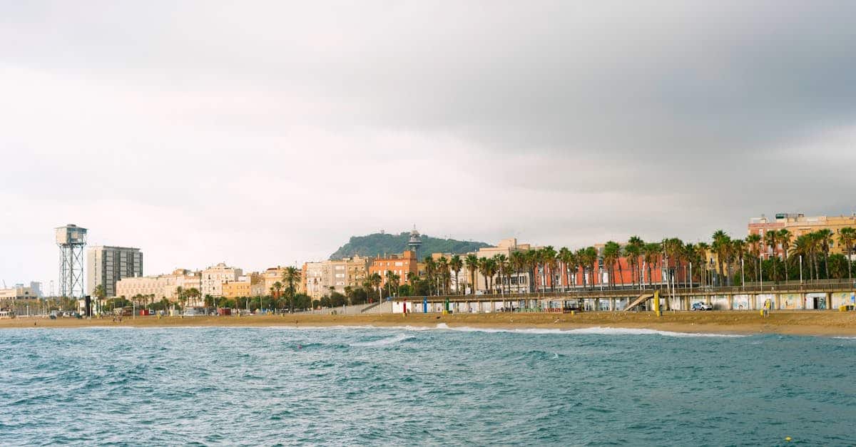 Barceloneta Beach in Barcelona with locals enjoying the sand and sea during sunset.