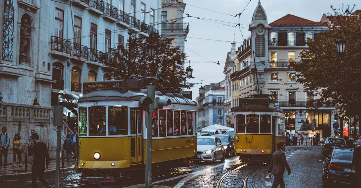 Scenic view of trams navigating the charming streets of Lisbon at dusk, capturing the city's urban life, transportation, and historic atmosphere.