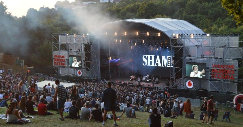 A lively outdoor concert at the Paredes de Coura music festival in Portugal, showcasing the country's vibrant live music scene.