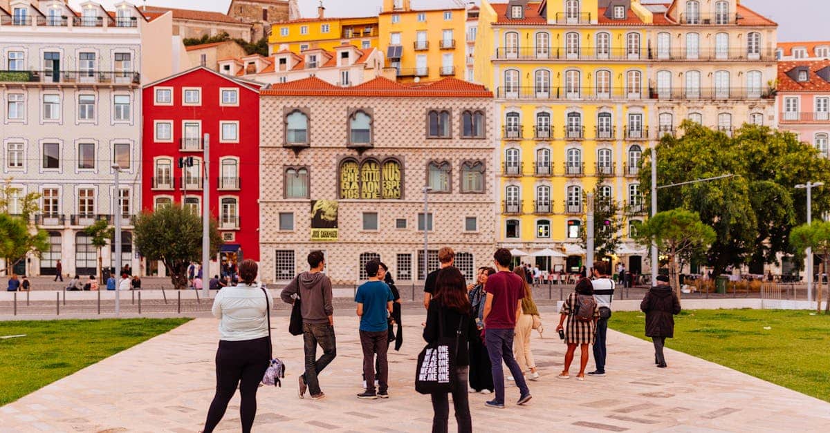 Vibrant Lisbon street scene featuring colorful buildings and a diverse group of tourists, capturing the city’s lively atmosphere and cultural diversity.