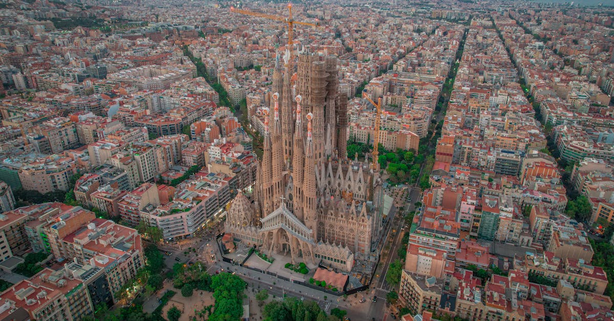 Aerial photograph of the Sagrada Familia in Barcelona, showcasing its iconic architecture and the surrounding cityscape.