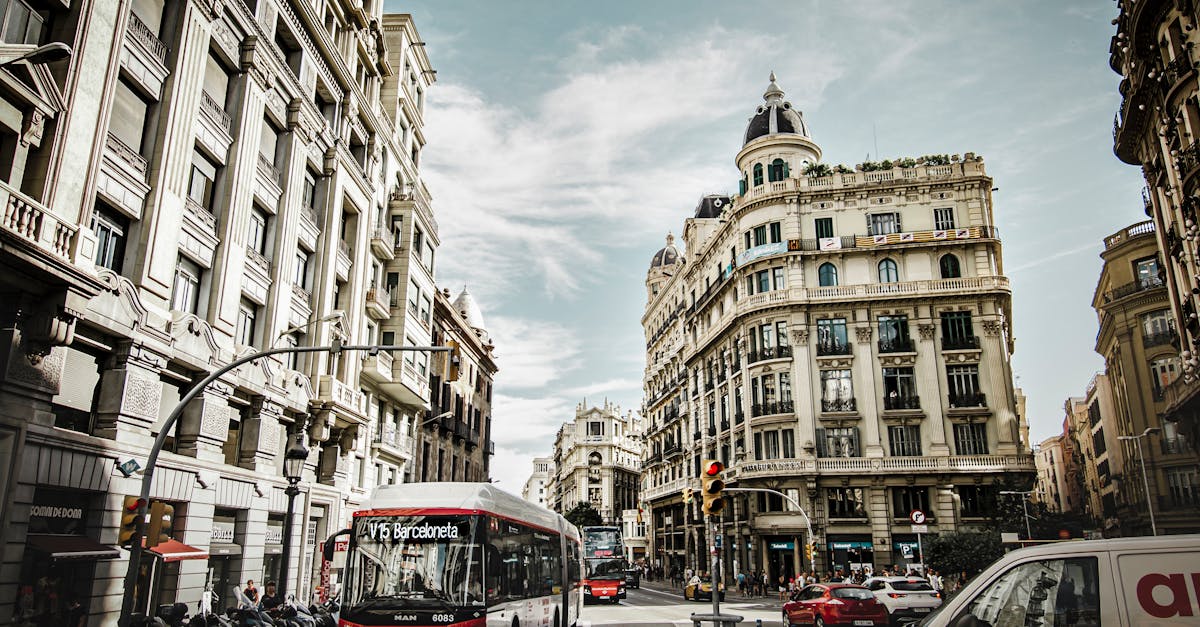 A vibrant street scene in Barcelona, Spain, showing city traffic and transport, highlighting commuting costs for expats.