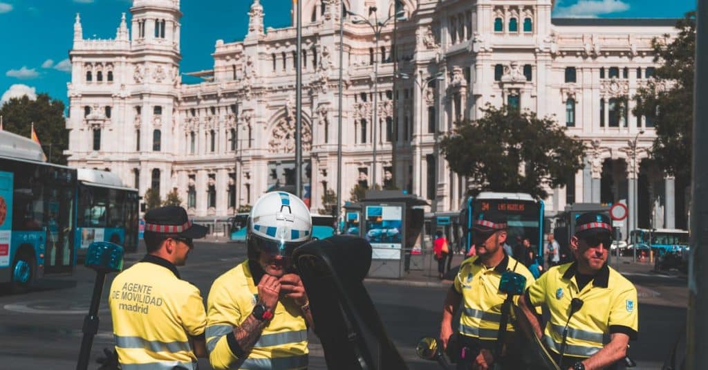 Police officers ensuring security at Plaza de Cibeles in Madrid, Spain, reinforcing public safety for tourists and residents.