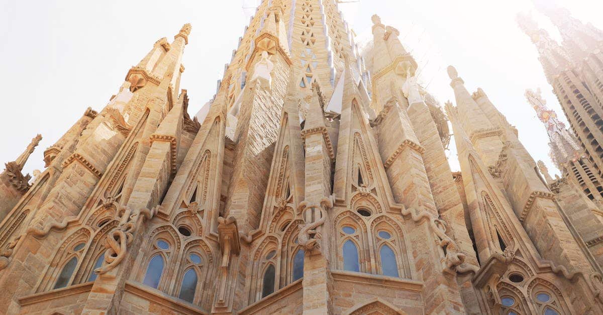 Low angle view of the iconic Sagrada Familia, showcasing its intricate architecture in Barcelona, Spain.