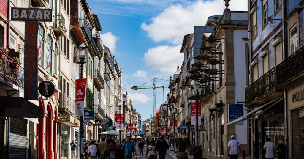Lively street scene in Porto, Portugal with shops and pedestrians under a bright blue sky, highlighting everyday expenses and local living options.