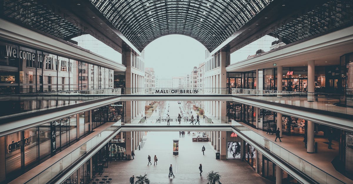 Explore the sleek and multi-level design of Mall of Berlin, showcasing modern architecture and shoppers enjoying a vibrant retail experience.