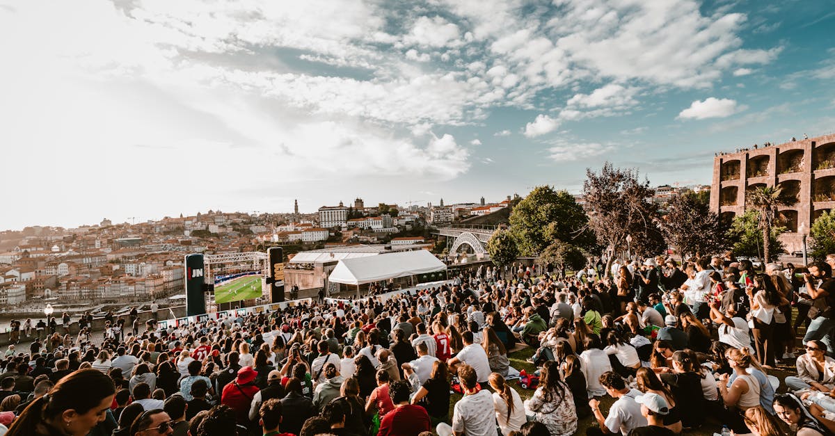 Hundreds of people gathered in Porto, Portugal, watching a football game on a big screen, reflecting the country’s vibrant community celebrations and festival-like atmosphere.