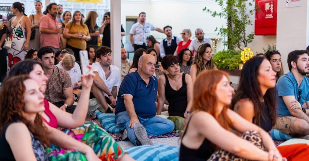 A diverse group enjoying a live music performance outdoors in Madrid, capturing togetherness and cultural celebration.