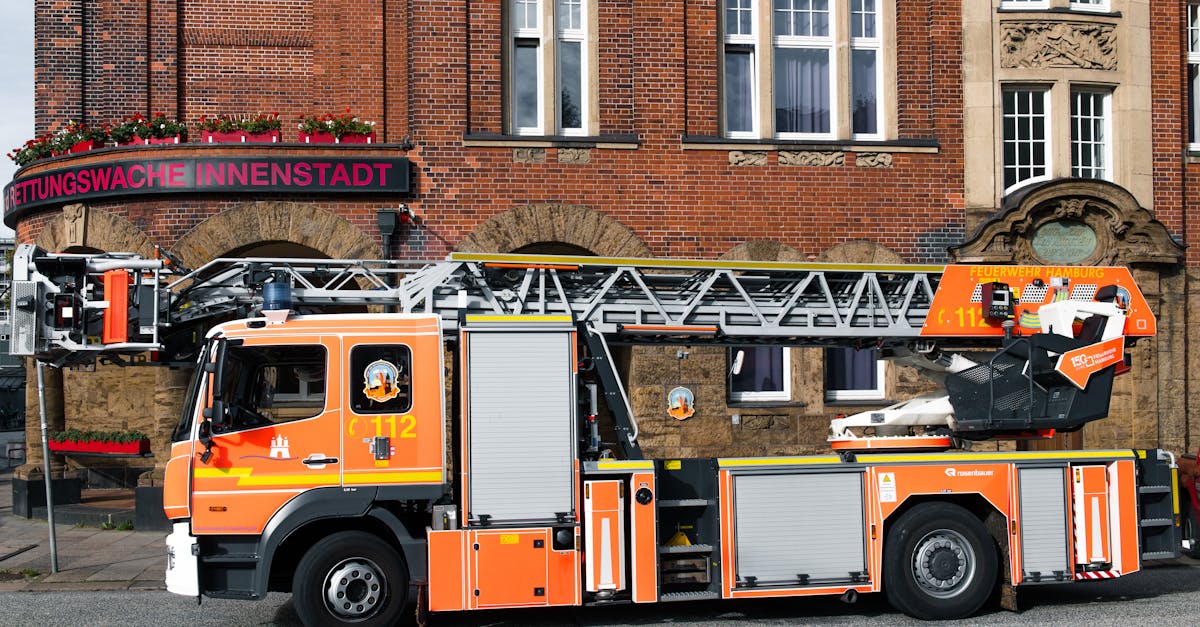 A fire truck parked outside the Rettungswache Innenstadt in Hamburg, representing emergency healthcare services and potential medical costs in Germany.