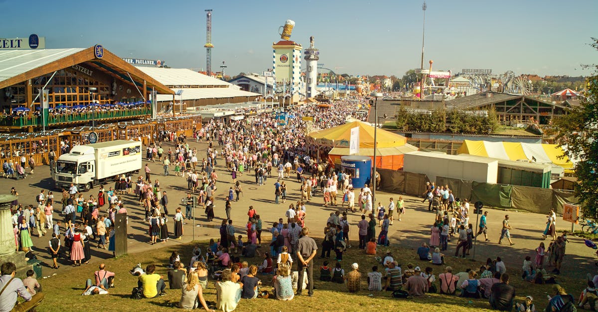 A bustling scene of people gathered at Oktoberfest in Munich, showcasing traditional Bavarian attire, beer tents, and a lively festival atmosphere.