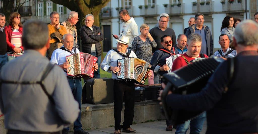 A lively outdoor accordion performance captivates a crowd in Braga, Portugal, showcasing the city's vibrant local culture.