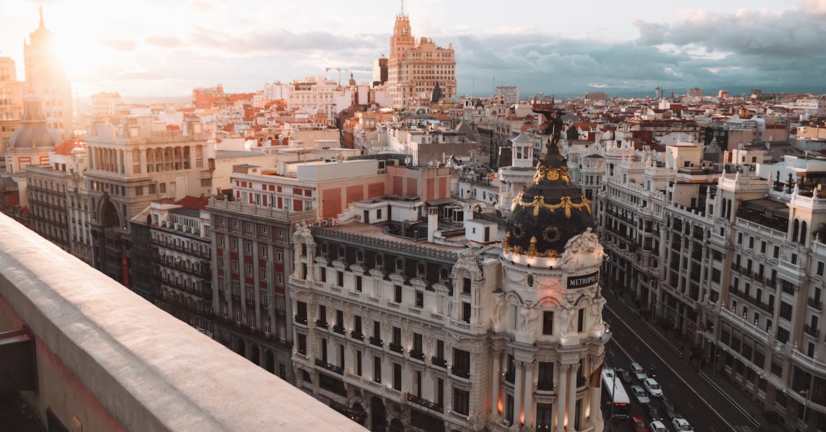 Breathtaking sunset view of Madrid’s skyline featuring the iconic Metropolis Building, showcasing the city's architectural beauty and vibrant atmosphere.