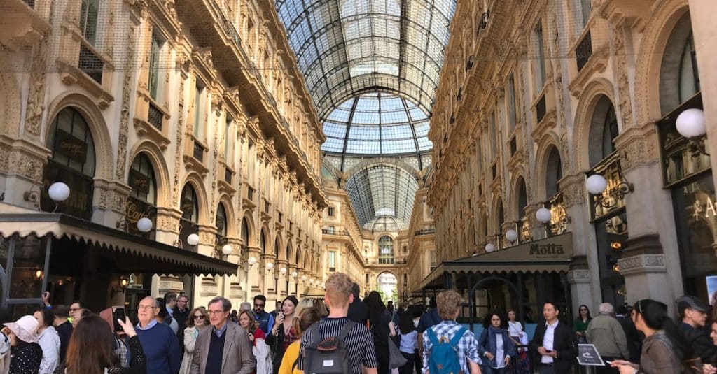 Bustling scene inside the historic Galleria Vittorio Emanuele II in Milan, Italy.