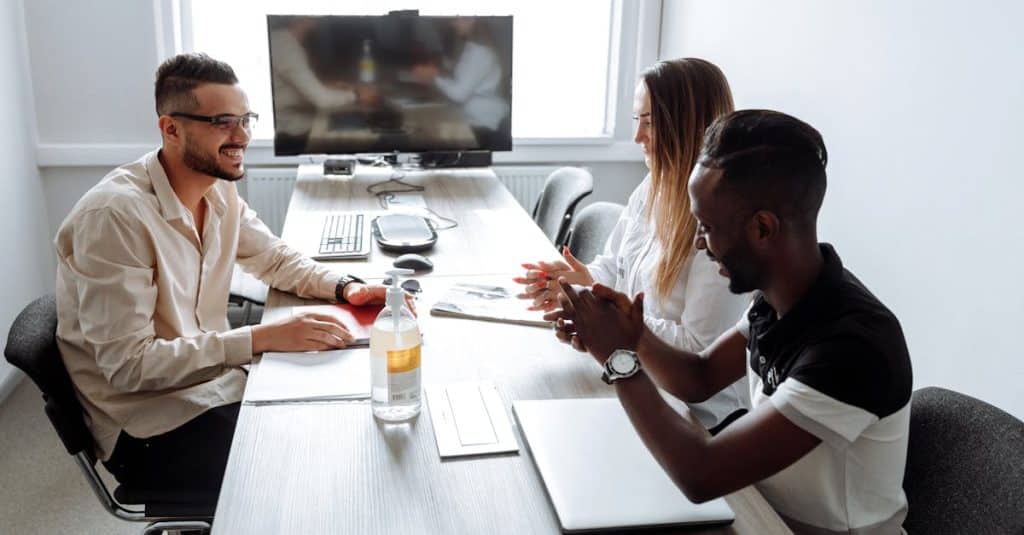 A corporate meeting with diverse professionals discussing strategies in a modern office setting, representing job opportunities and economic growth in Germany.