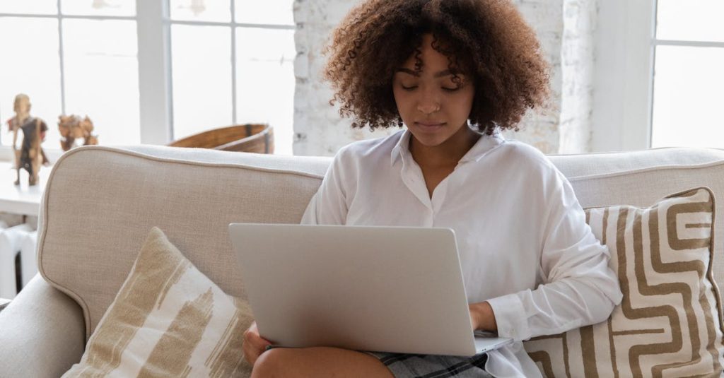 A professional browsing job listings on a laptop, representing job hunting tips for expats in Paris and Marseille, France.