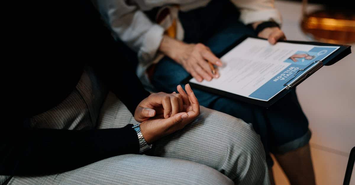 Two professionals reviewing a resume in an office setting in Portugal, highlighting teamwork and the job market process.
