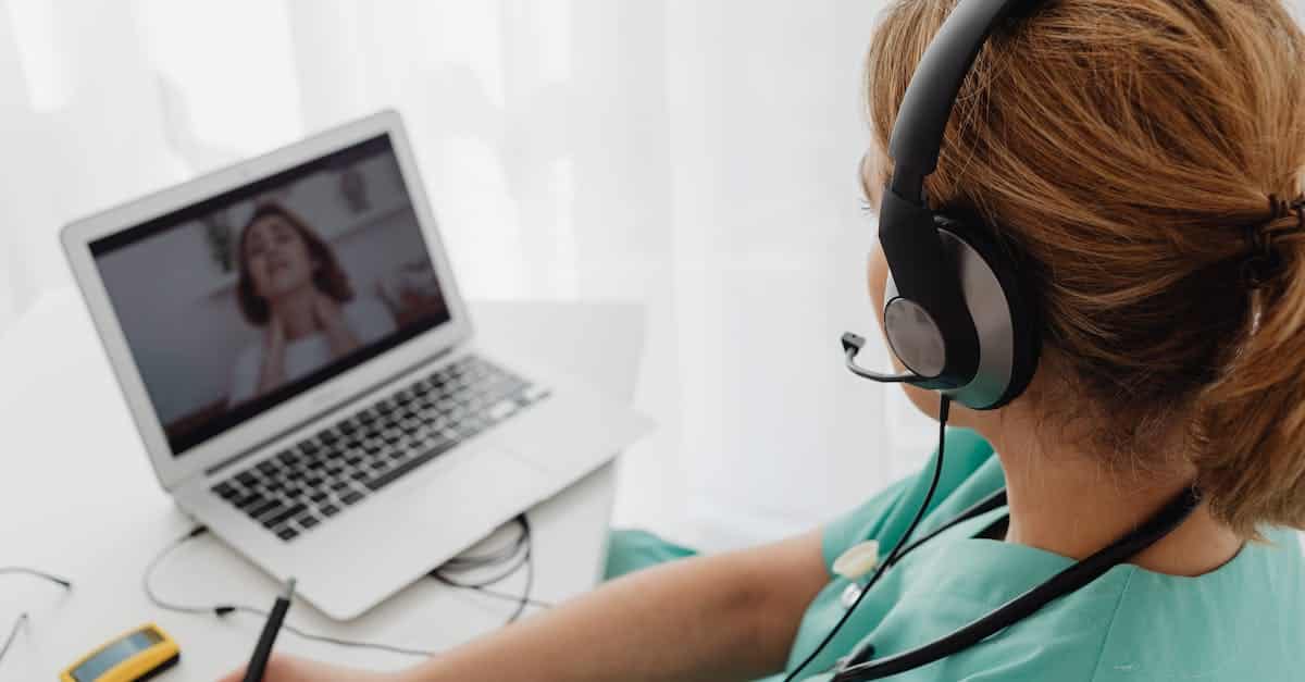 Medical professional consulting a patient online via laptop, highlighting telehealth services available to expats in Portugal.