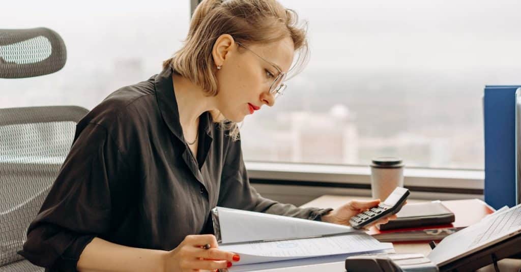 A person filling out French administrative paperwork, representing visa, residency, and bureaucratic processes for expats in France.