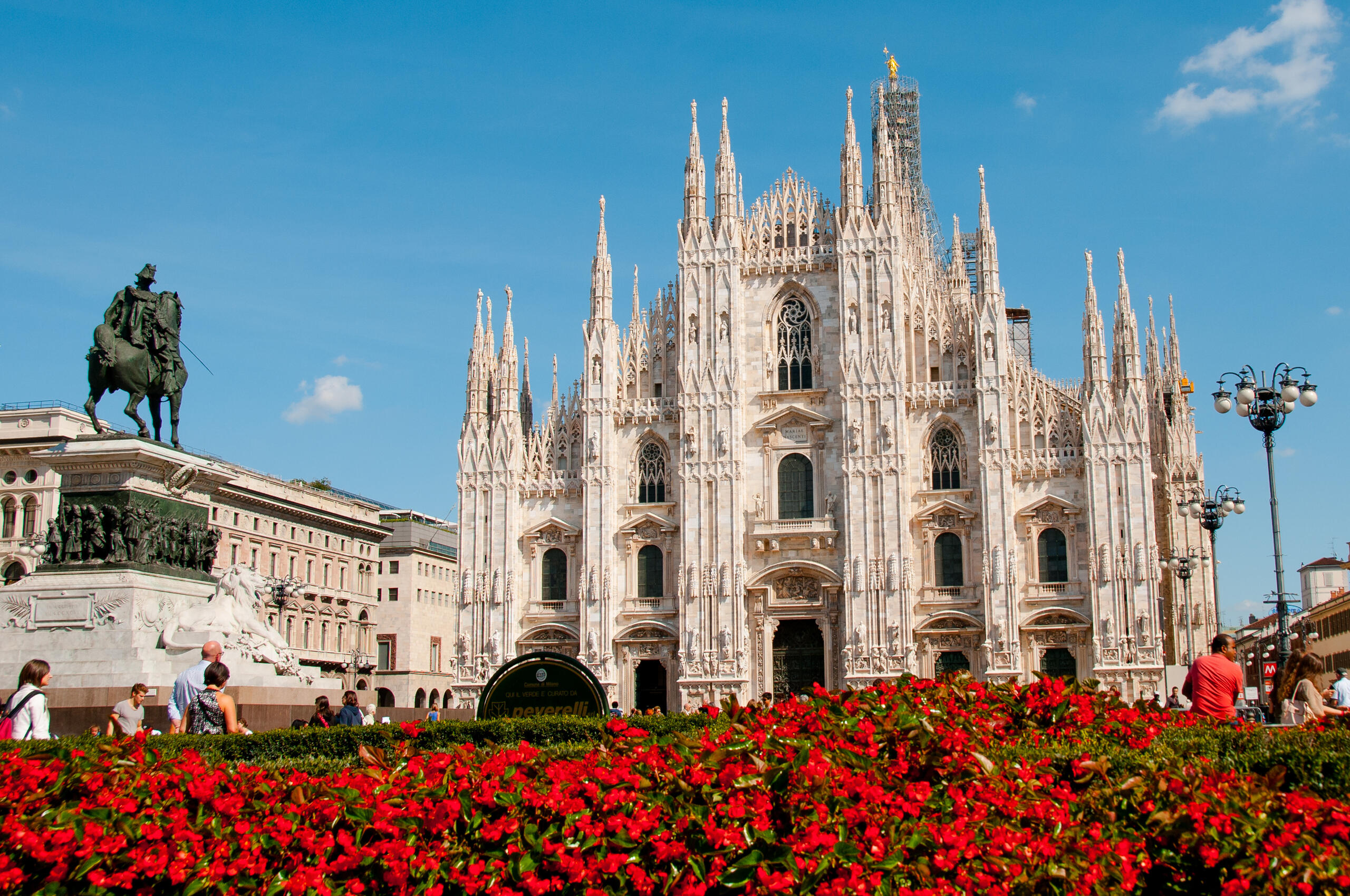 Milan Cathedral (Duomo di Milano) in Piazza del Duomo, with people enjoying the historic square.