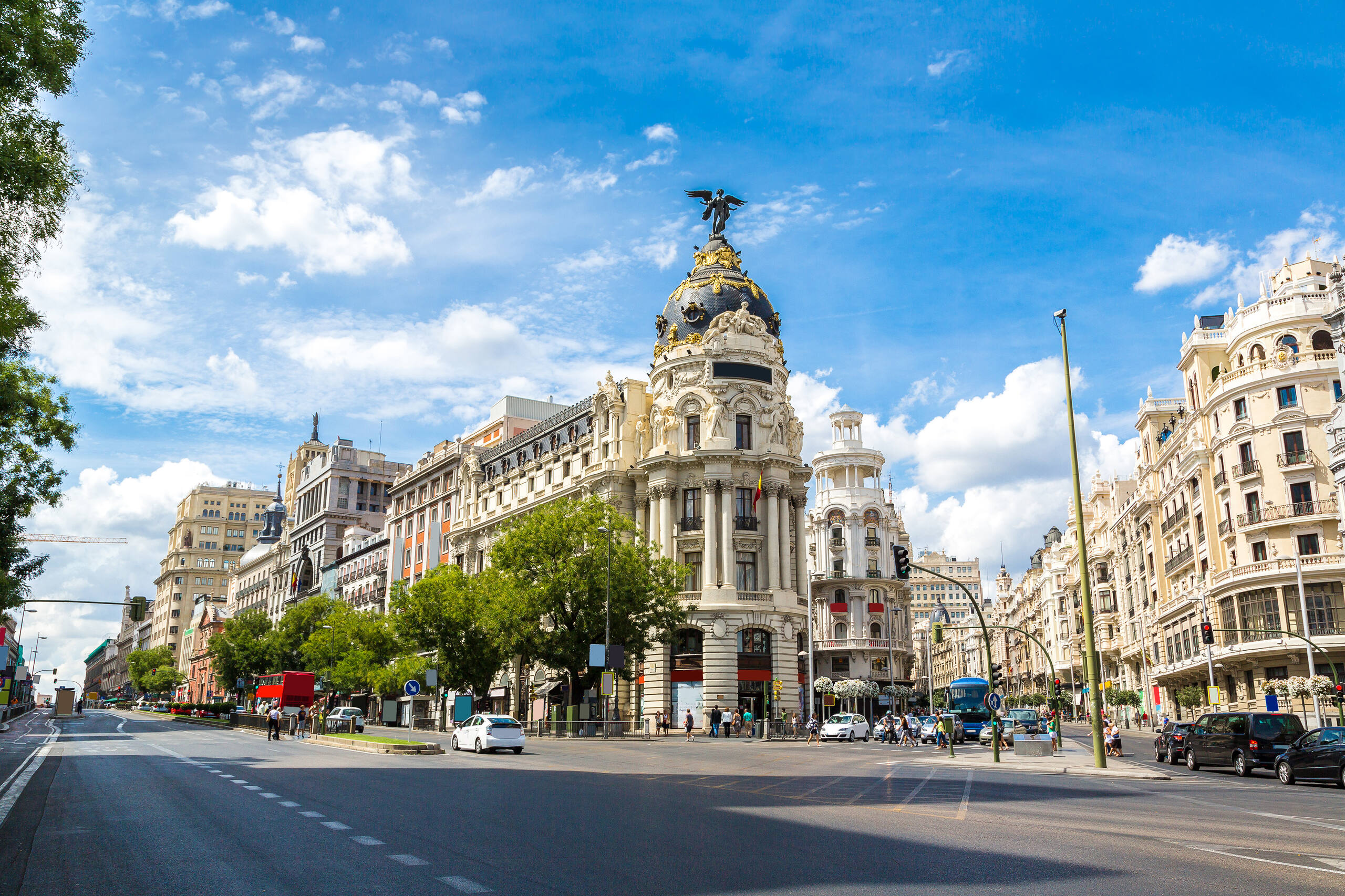 Panoramic city view of Madrid, Spain, featuring the Gran Vía, Metropolis Building, and vibrant streets.