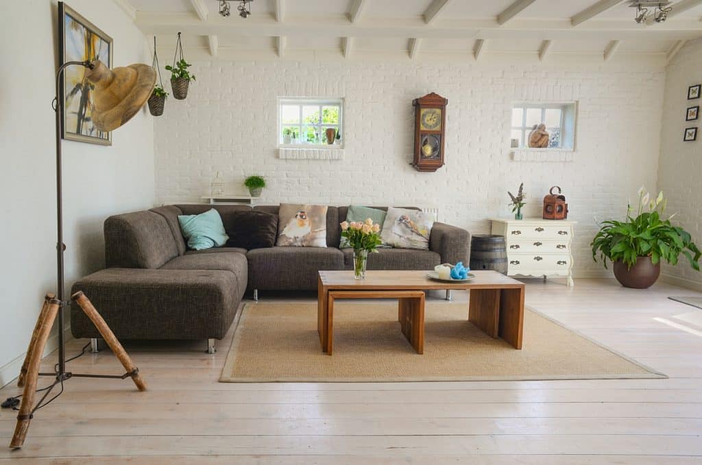 A cozy, well-lit living room with soft textures, warm lighting, and stylish decor, showcasing renter-friendly ways to create a welcoming atmosphere.