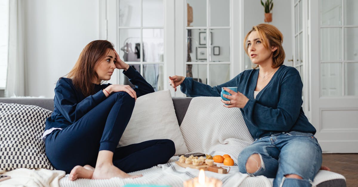 Two roommates having a supportive conversation in their shared apartment, promoting mental health and well-being in co-living spaces.