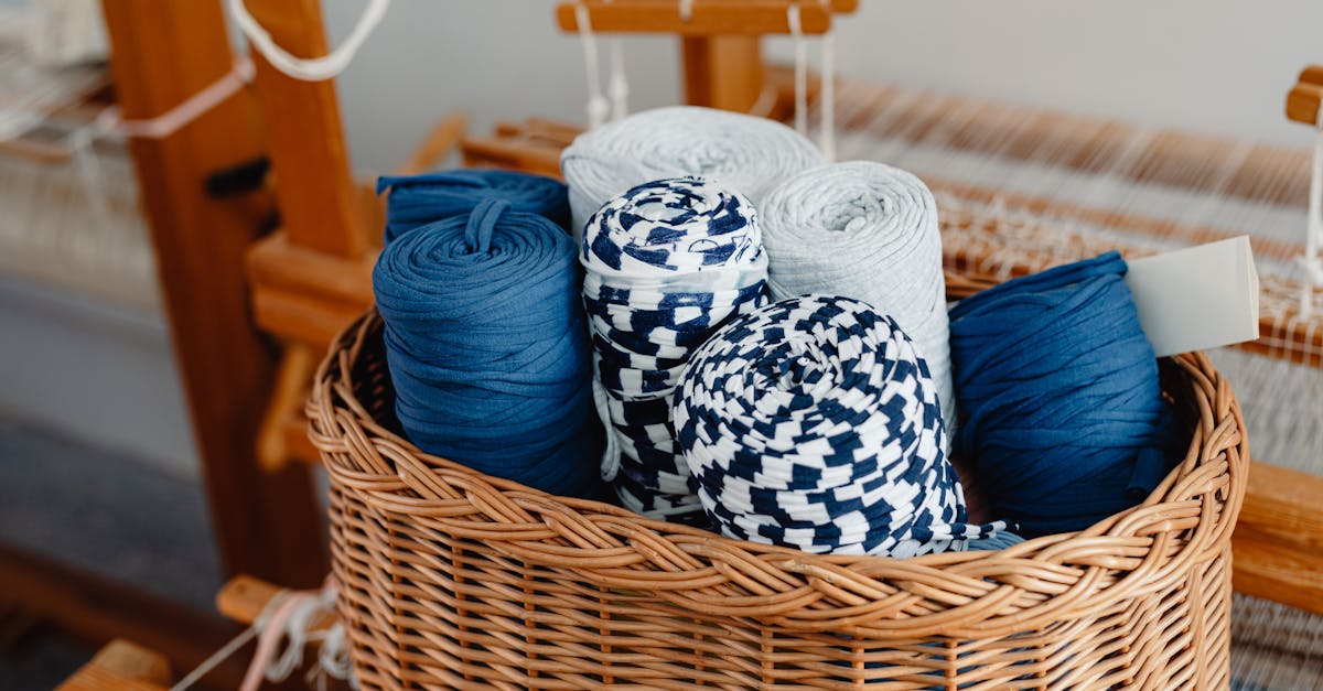 A wicker basket filled with colorful threads on a loom, perfect for arts and crafts enthusiasts creating DIY rugs for budget-friendly home decor.