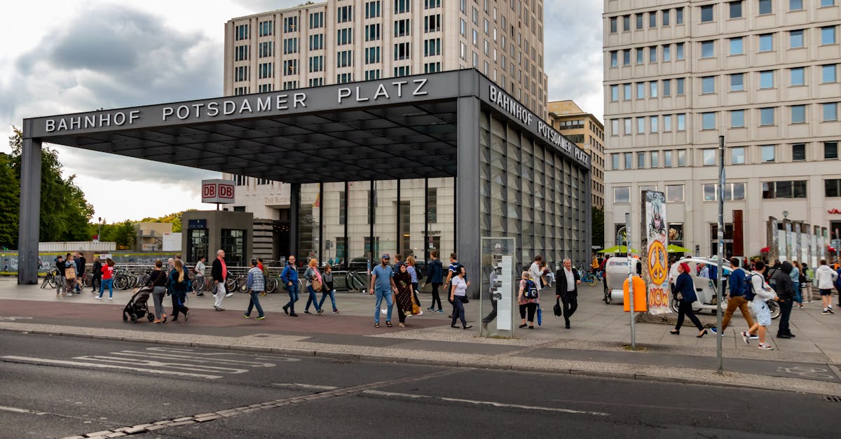 A crowd of people walking near Bahnhof Potsdamer Platz in Berlin, Germany, showcasing the vibrant and modern city life of Berlin’s neighborhoods.
