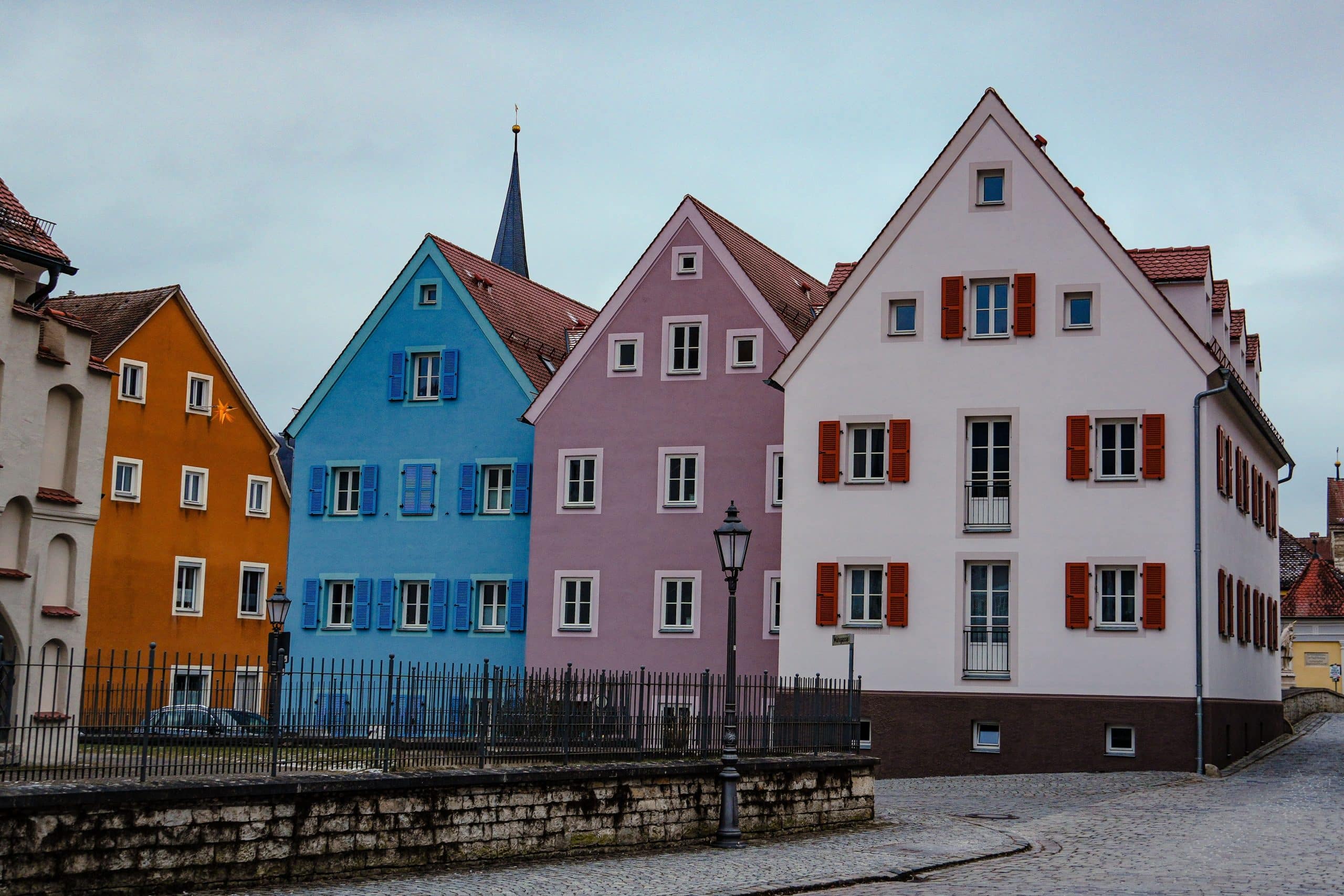 A charming view of colorful historic houses on a cobblestone street in Germany, ideal for travel photography.